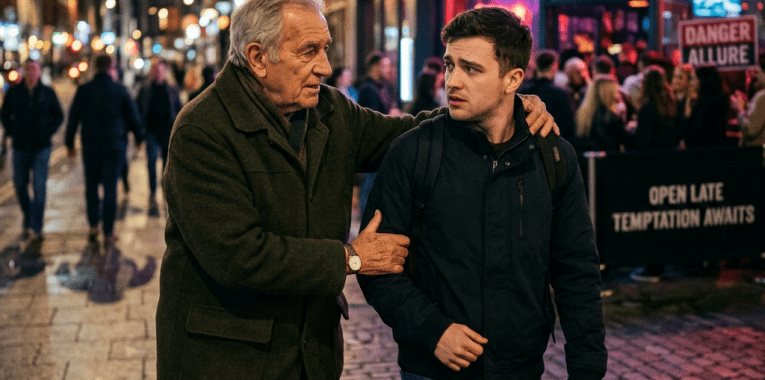 Older man placing hand on younger man's shoulder while walking on city street at night